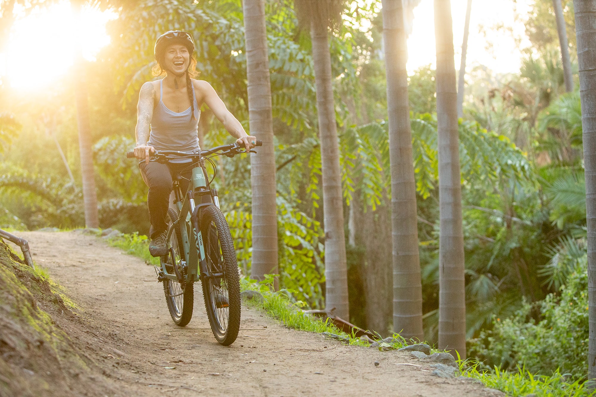 Girl riding mountain bike on trail